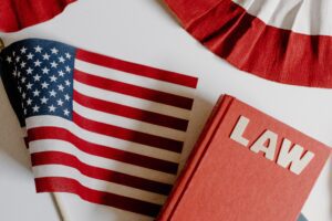 Photo of American flag beside a law book on white background