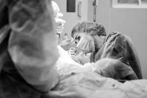 Grayscale Photo of a Doctor Doing a Surgery